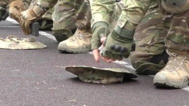 Poltava-Kharkiv region, Ukraine - August 2022: Ukrainian military man receives cartridges for a machine gun. A soldier of a volunteer formation of a territorial community inserts cartridges into a gun horn. Cartridges in the hands of a soldier