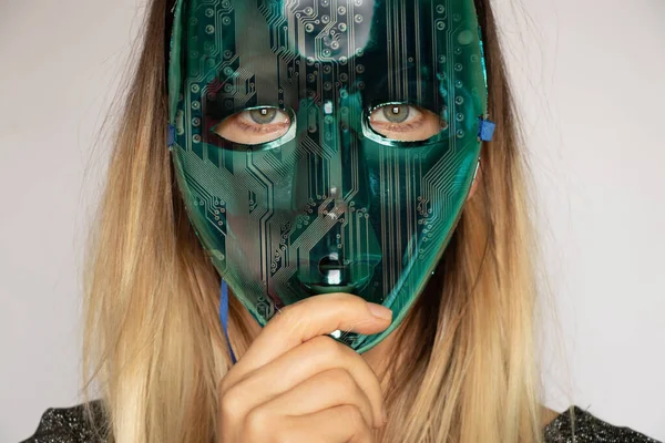 young girl in a blue plastic mask with a matrix system overlay effect from above on an isolated background, face mask, robots and people, technology, artificial intelligence, new technologies
