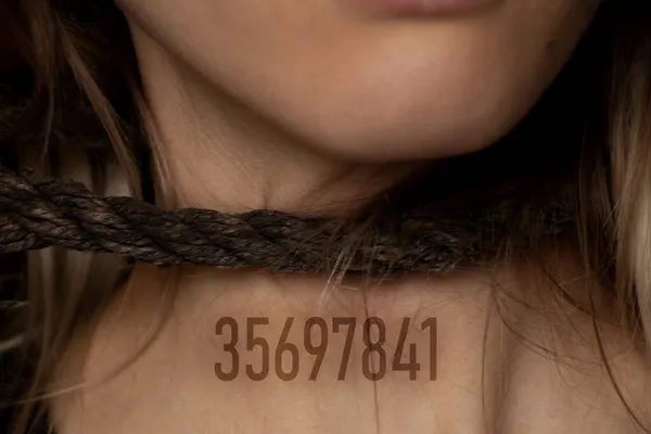 girl with a rope around her neck and a digital number on her chest, human trafficking, slavery, power over people, rope around a person's neck