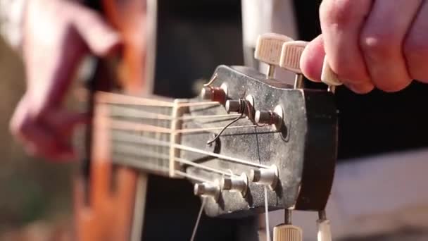 Mann spielt Gitarre im Freien in der Sonne aus nächster Nähe, spielt Gitarre — Stockvideo