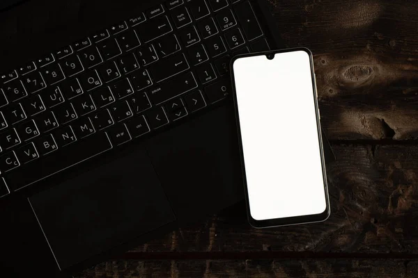 Masadaki Siyah Dizüstünde Beyaz Ekranlı Bir Telefon Beyaz Ekranlı Bir — Stok fotoğraf