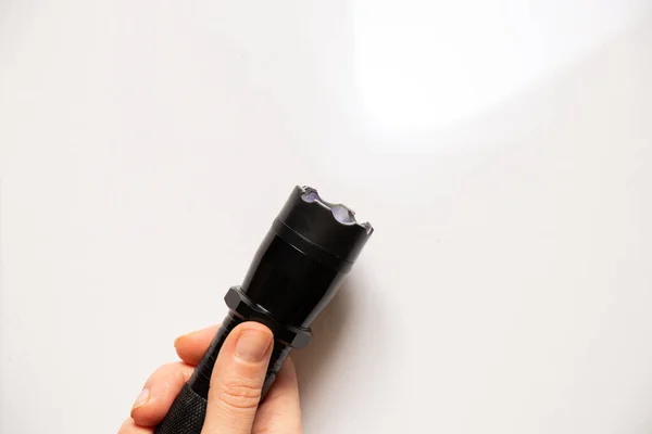 stun gun flashlight to scare off dogs on an isolated background, protection from dogs, flashlight schoker