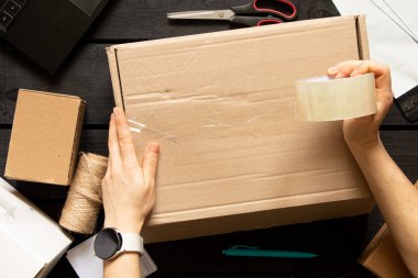 Kadın çevrimiçi mağazası, küçük işletme sahibi, girişimci, paketleme çantası, posta kutusu hazırlama paketi. E-ticarette sevkiyat konsepti düştü. Ürün ambalajı.