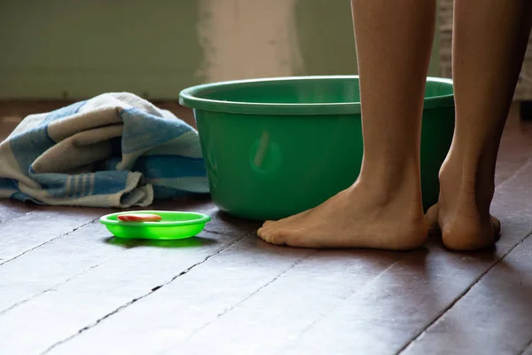 Uma Menina Lava Pés Uma Bacia Verde Com Água Chão — Fotografia de Stock