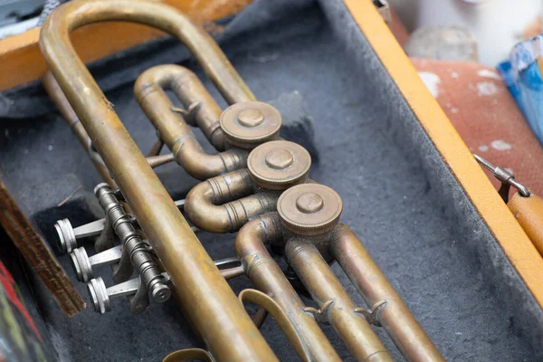 Old musical trumpet in a wooden box close up,music and hobby