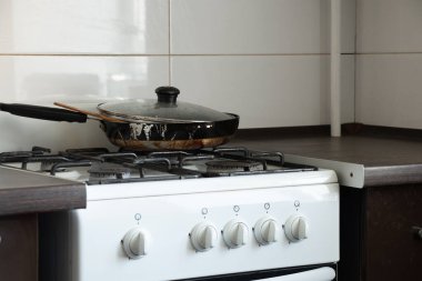 Ukrayna 'da bir dairede, mutfakta gaz ocağı ve kirli kızartma tavası, mutfak mobilyası ve aletler, mutfak iç mimarisi.