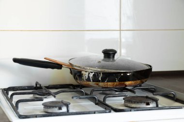 Ukrayna 'da bir dairede, mutfakta gaz ocağı ve kirli kızartma tavası, mutfak mobilyası ve aletler, mutfak iç mimarisi.