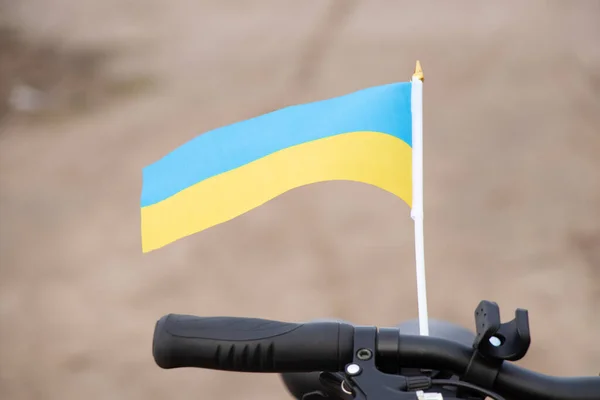 Yellow-blue flag of Ukraine on a bicycle in a city in Ukraine, a protest action, stop the war in Ukraine, a patriot of his country 2022