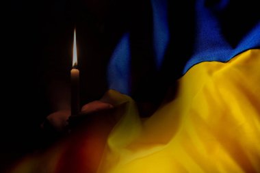 The national flag of Ukraine is yellow and blue against the background of a candle, we mourn those who died in the war in Ukraine 2022 clipart