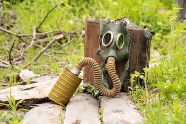 Antique gas mask lies on the street in the forest, gas attack in Ukraine at war, protective mask, ecology, chemical attack during the war