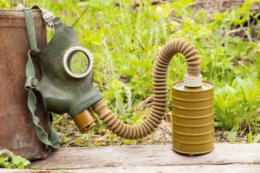 Antique gas mask lies on the street in the forest, gas attack in Ukraine at war, protective mask, ecology, chemical attack during the war