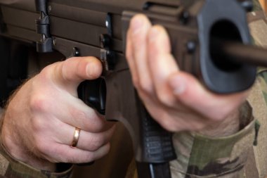 A Ukrainian soldier in military uniform holds a machine gun, the war in Ukraine and the protection of his home and family 2022