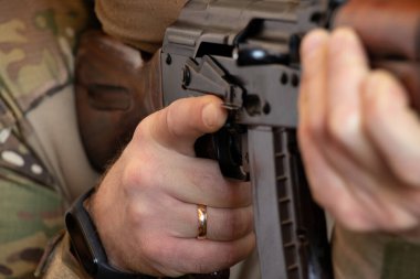 A Ukrainian soldier in military uniform holds a machine gun, the war in Ukraine and the protection of his home and family 2022