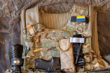 Military reinforced bulletproof vest and pistol, weapon, uniform of a Ukrainian soldier in the war, army of Ukraine 2022