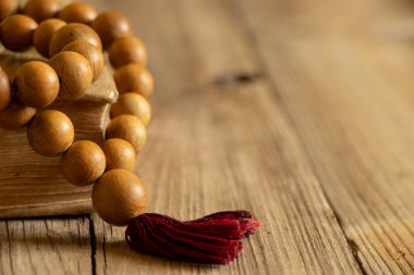 Wooden rosary lie on the bible on a wooden table, bible and religion, faith and God