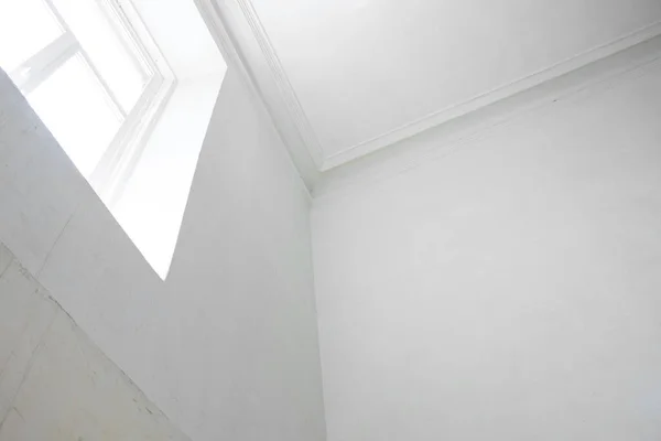 Corner of a white wall, a window in a white wall in a building in Ukraine, building and interiors