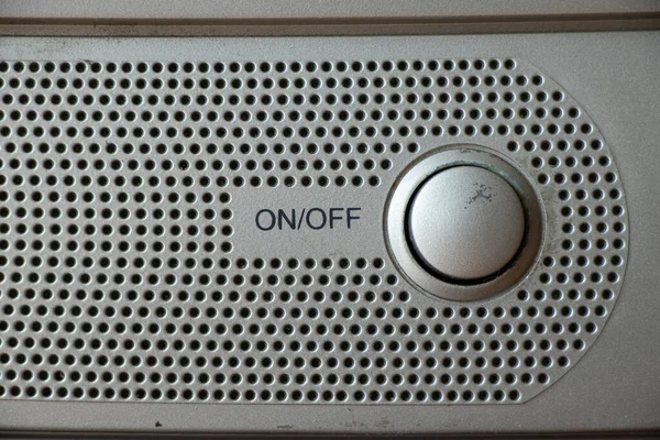 Buttons on an old gray TV close-up turn on and off, watch TV, buttons and a speaker on the TV
