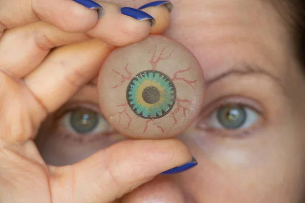 The girl holds a ball in the form of an eye on her forehead between the eyes, the third eye, clairvoyance