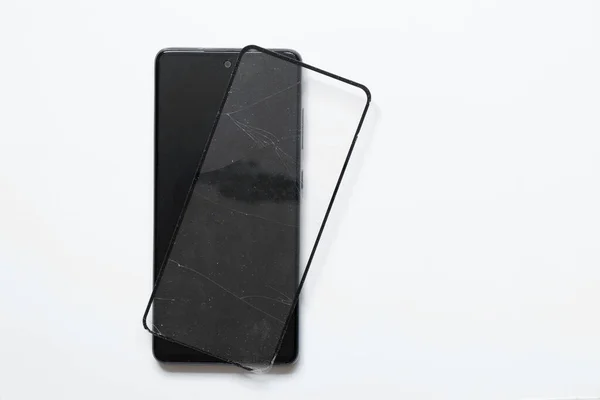 Phone Broken Protective Glass Lies Nearby White Background Replacement Protective — Φωτογραφία Αρχείου