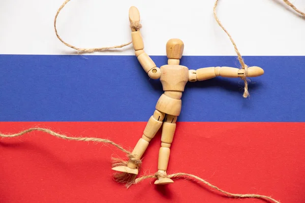 Wooden Man His Hands Feet Tied Lies Flags Russia People — Stock Photo, Image