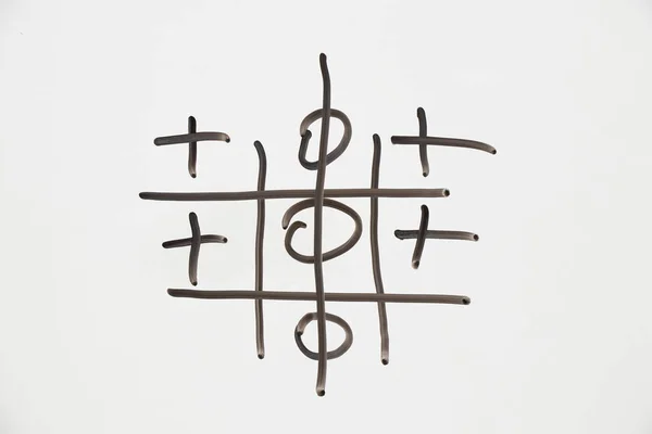 Tic Tac Toe is drawn in black on white, the Tic Tac Toe game is drawn by hand