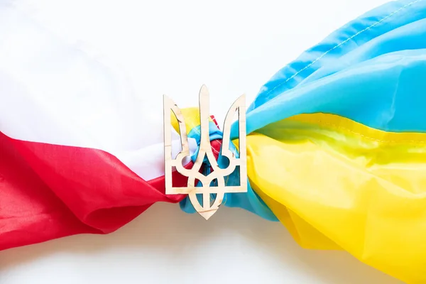 The Ukrainian trident lies on the flags of Poland and Ukraine, the unification of the two countries, the union and friendship between Ukraine and Poland during the war
