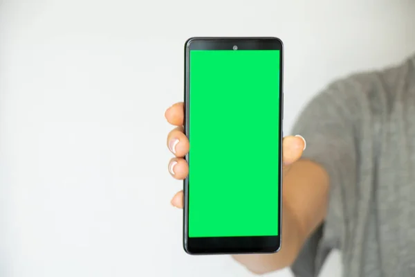 Girl White Background Her Hand Holds Mobile Phone Green Screen — Foto de Stock