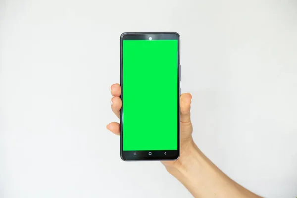 Girl White Background Her Hand Holds Mobile Phone Green Screen — Foto de Stock