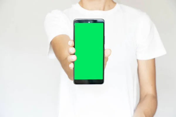 Girl White Background Her Hand Holds Mobile Phone Green Screen — Zdjęcie stockowe