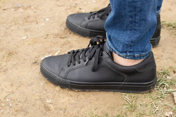 Les Pieds Des Hommes Baskets Jeans Noirs Tient Sur Sol — Photo