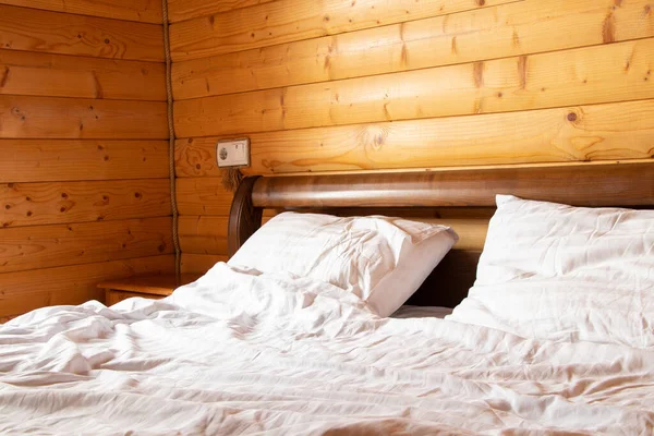 Double bed in a bedroom in a wooden house, apartment and interior, bed and bedroom