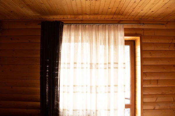 A window in a wooden house, a bedroom with a window in a wooden house, an ecological house