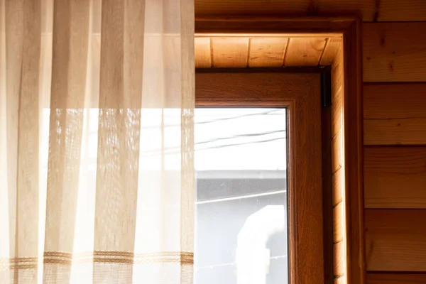 A window in a wooden house, a bedroom with a window in a wooden house, an ecological house