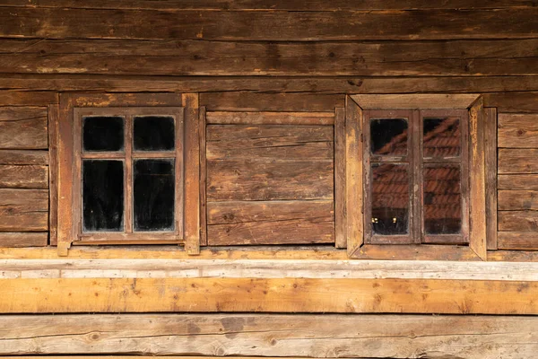 Wooden old house with windows in Ukraine, the window is old
