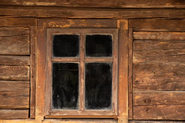 Wooden old house with windows in Ukraine, the window is old