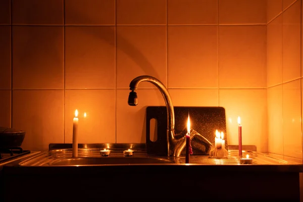 Apartment without electricity, kitchen by candlelight, Ukraine without electricity due to the war, in the dark