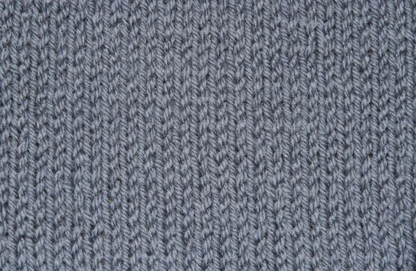 Textuur van hand-gebreide grijze wol Stockfoto