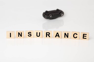 Car insurance concept of a car lying upside down.