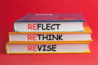 Books with words Reflect Rethink Revise on red background.