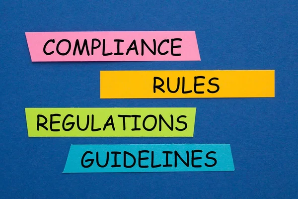 The words Compliance, Rules, Regulations and Guidelines on colorful stickers.