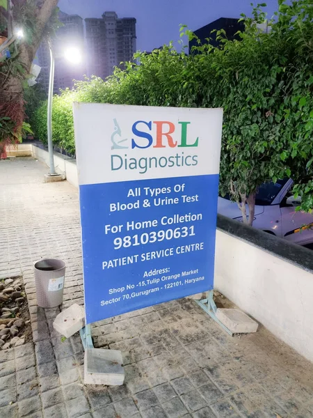 SRL laboratory diagnostic center board in gurgaon showing the many centers testing for covid 19 coronavirus during the omicron wave — стокове фото