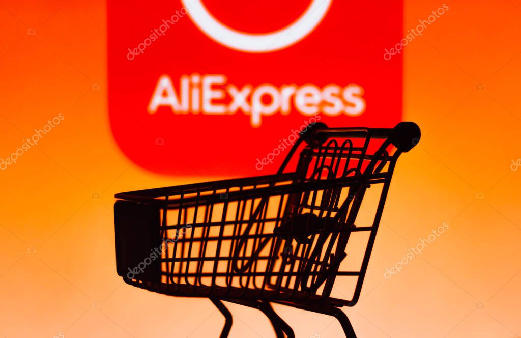 October 4, 2021, Brazil. In this photo illustration a shopping cart is seen in front of the AliExpress e-commerce company logo