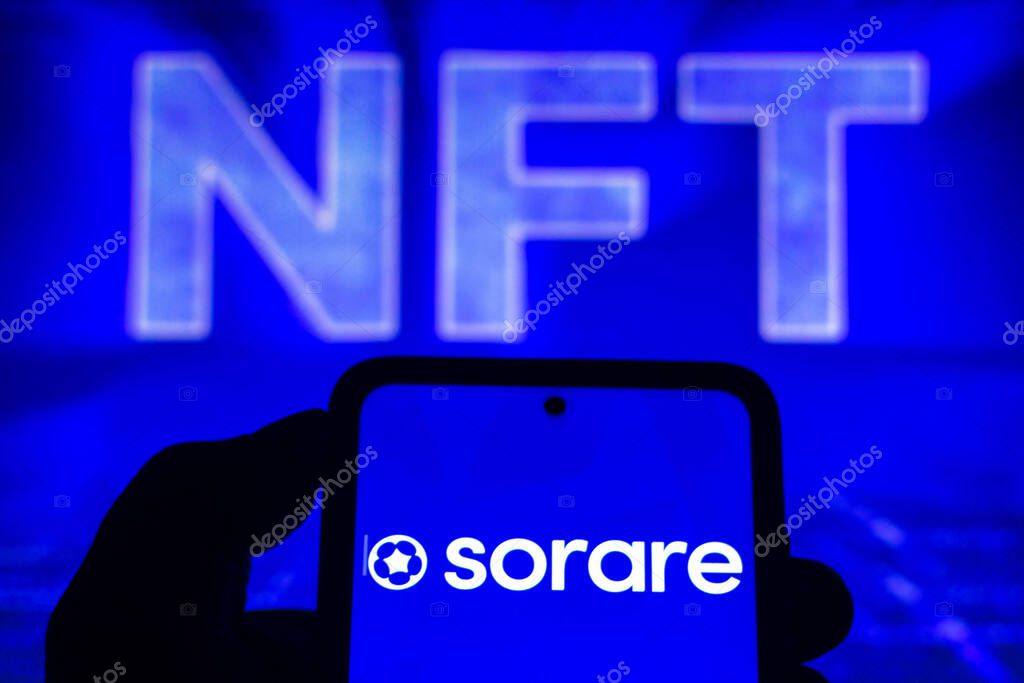 October 13, 2021, Brazil. In this photo illustration, Sorare logo seen displayed on a smartphone and logo NFT (non-fungible-token) the background