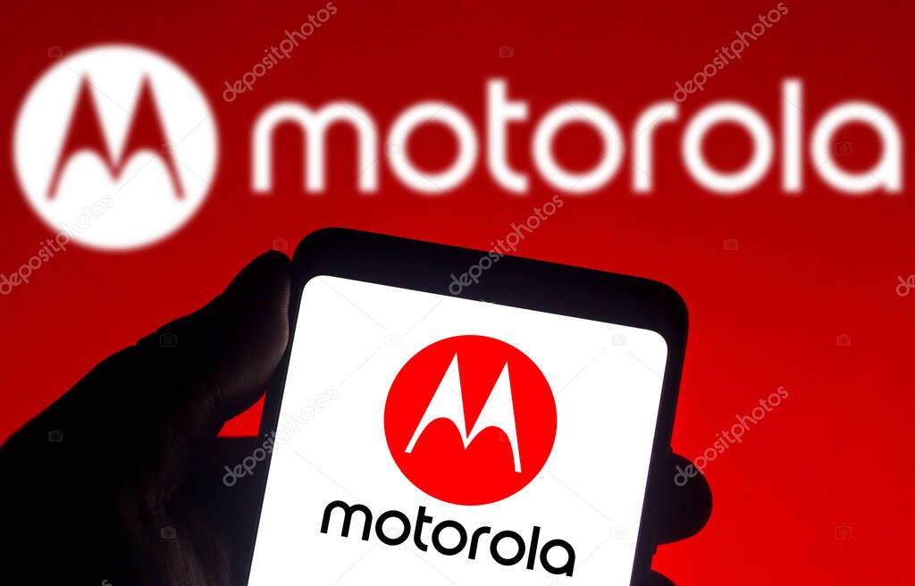 December 14, 2021, Brazil. In this photo illustration the Motorola logo seen displayed on a smartphone and on the background