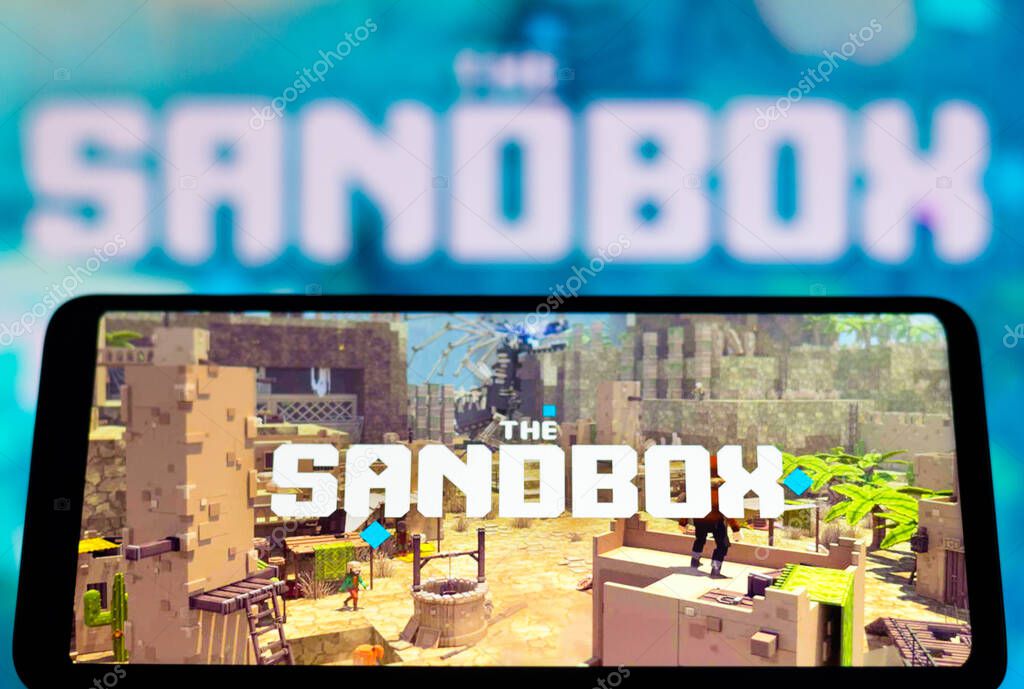February 4, 2022, Brazil. In this photo illustration, the Sandbox logo seen displayed on a smartphone screen and in the background