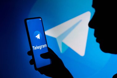 19 Mart 2022, Brezilya. Bu resimde, bir kadın ekranda ve arka planda Telegram logosu olan bir akıllı telefon tutuyor.