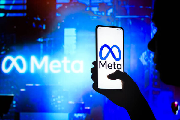 April 10, 2022, Brazil. In this photo illustration, a woman holds a smartphone with the Meta Platforms, Inc. logo displayed on the screen