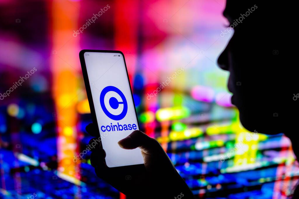 April 12, 2022, Brazil. In this photo illustration, a woman holds a smartphone with the Coinbase logo displayed on the screen
