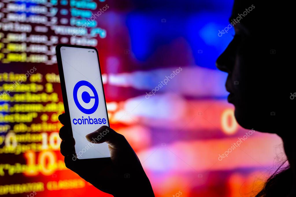 April 12, 2022, Brazil. In this photo illustration, a woman holds a smartphone with the Coinbase logo displayed on the screen