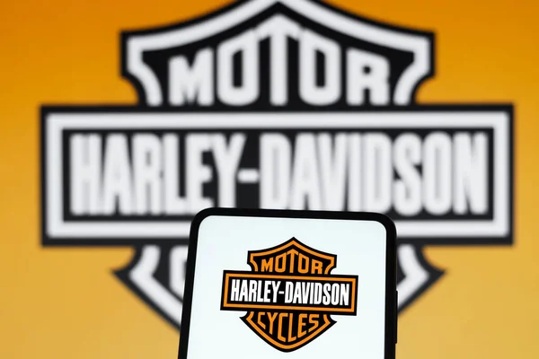 stock image July 5, 2022, Brazil. In this photo illustration, the Harley-Davidson Motor Cycles logo is displayed on a smartphone screen and in the background
